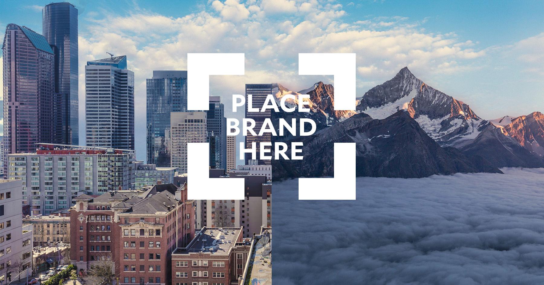 A city skyline joined to a mountain range, with “Place brand here” set in a white viewfinder frame.