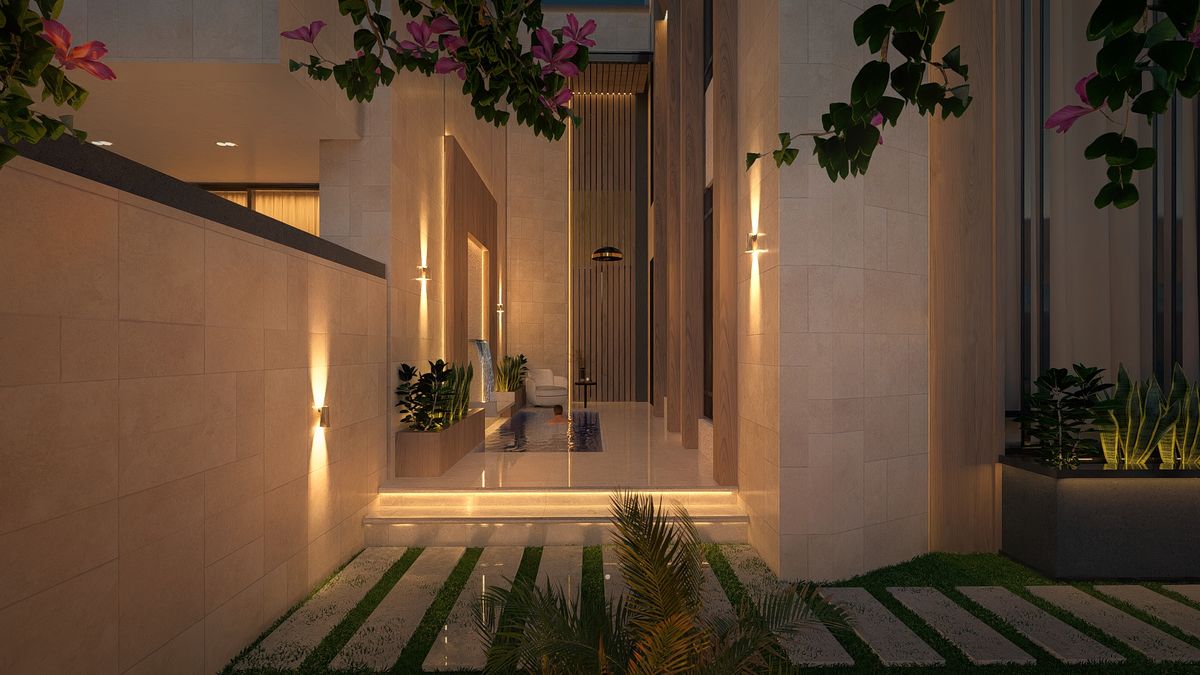 المدخل مساءً بإضاءة دافئة ونباتات متسلّقة