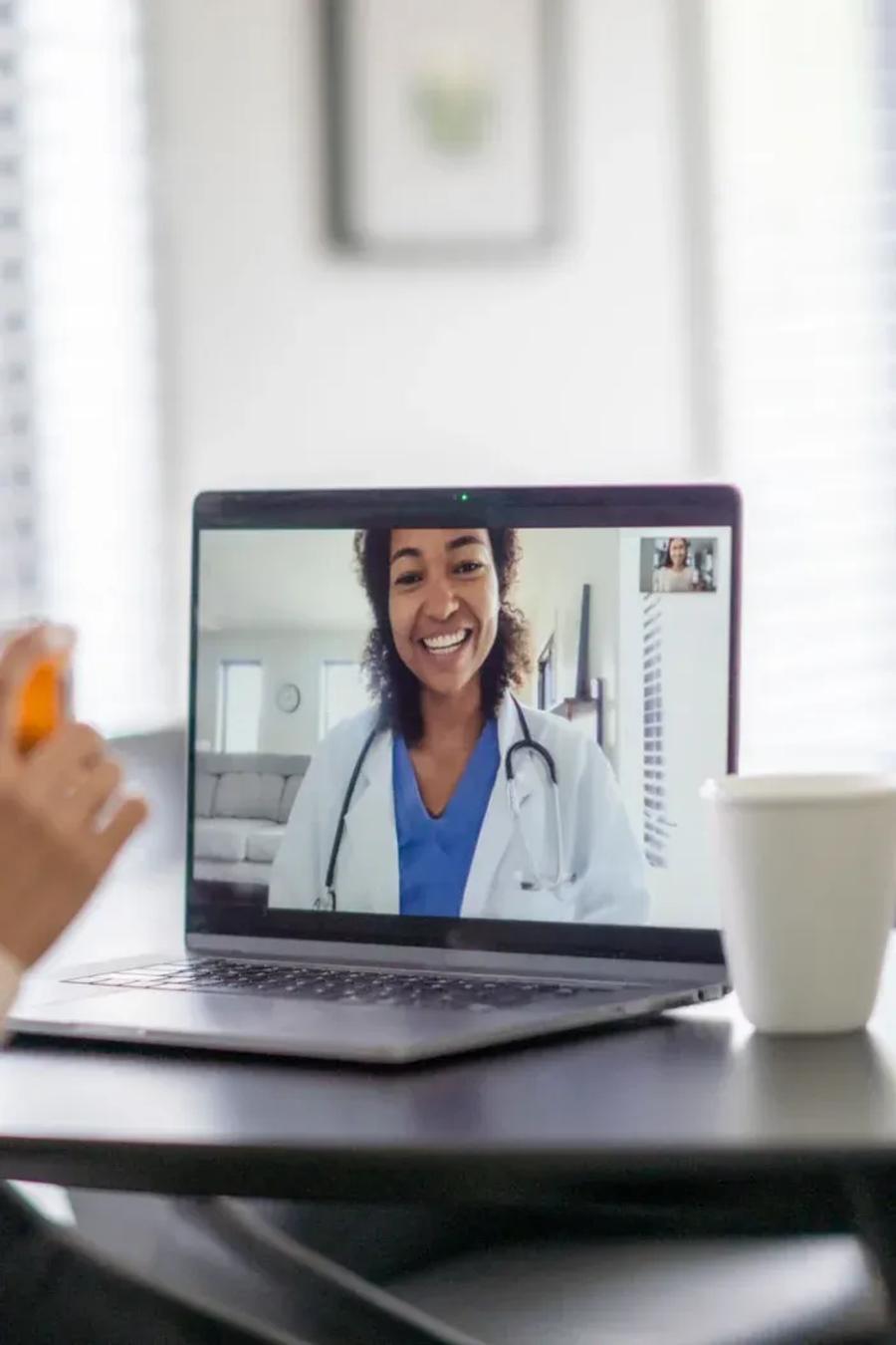 A patient on a video call with her dentist from home