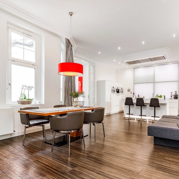 Dining area with 4 designer chairs with backrests.