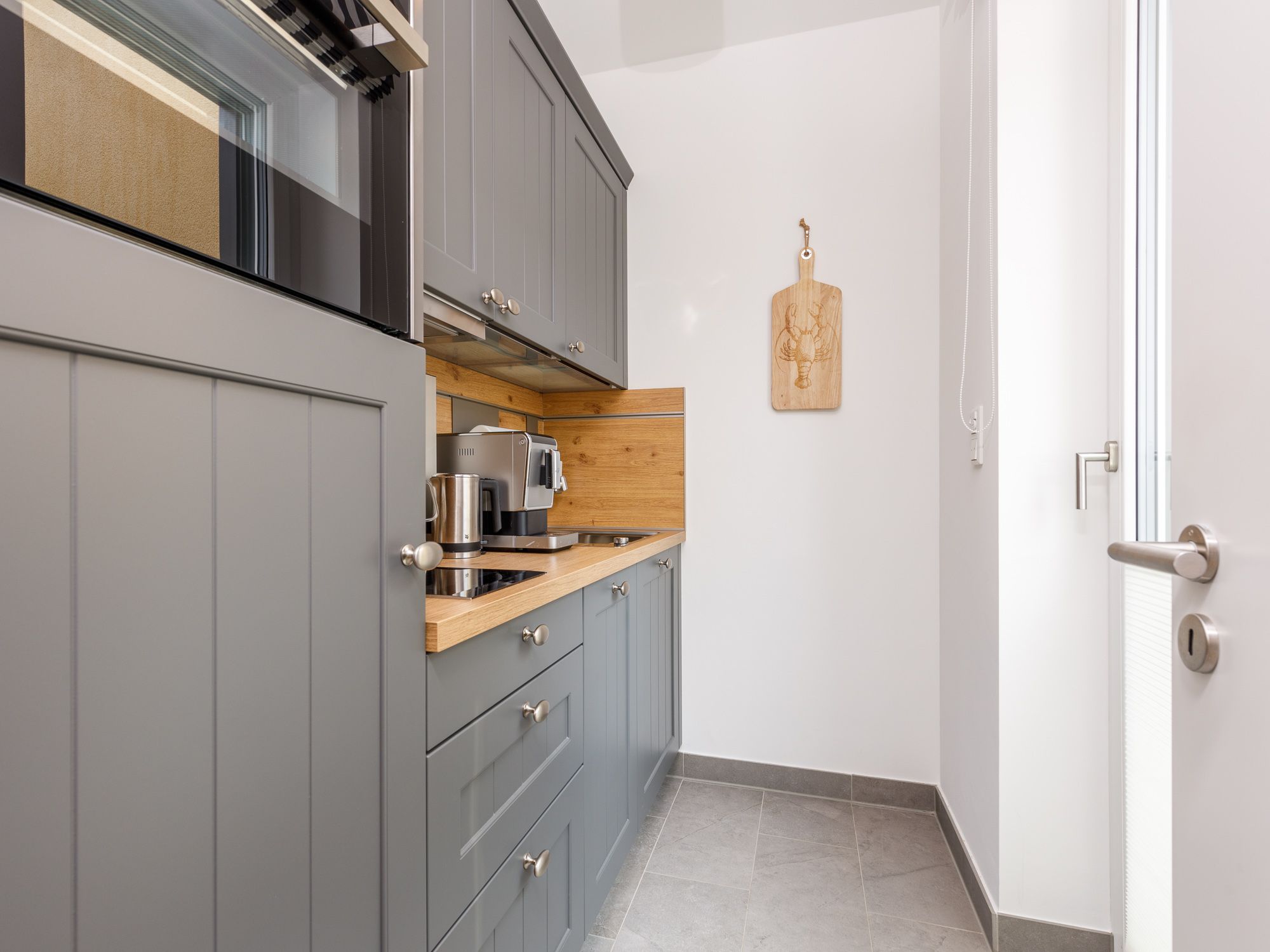 Separate kitchen area with modern appliances 