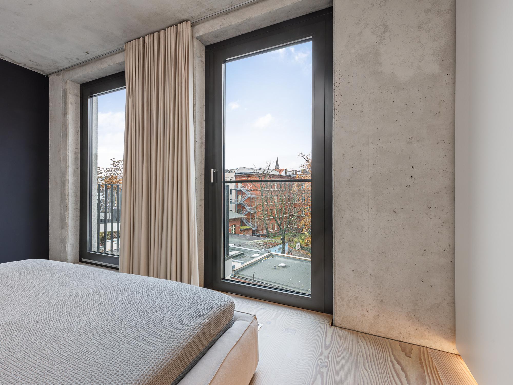 Schlafbereich mit bodentiefen Fenstern und Fußbodenheizung 