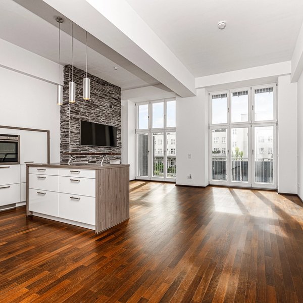 living area sofa windows wooden flooring