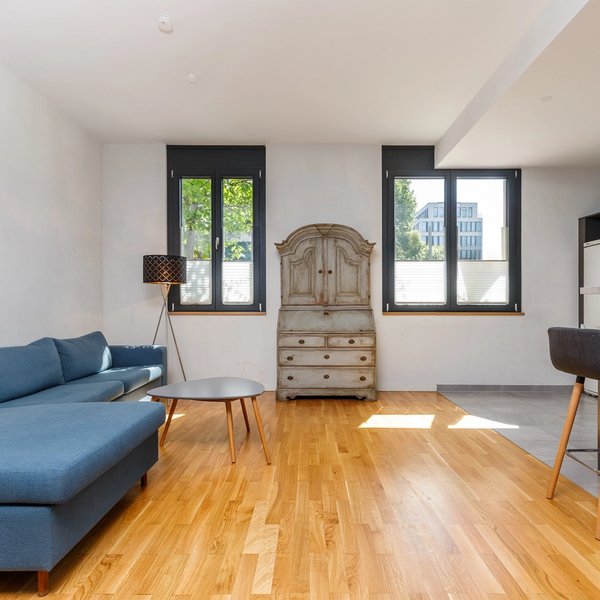 Living area sofa parquet flooring window front