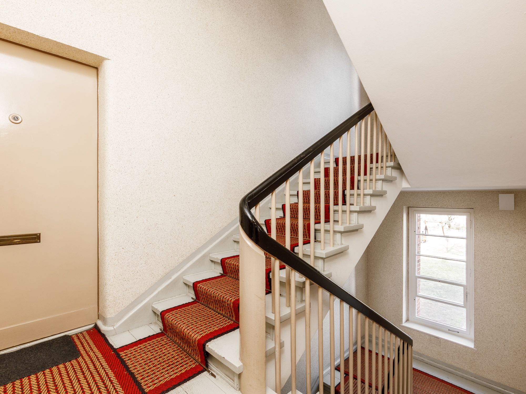 Well-maintained staircase with sisal carpet