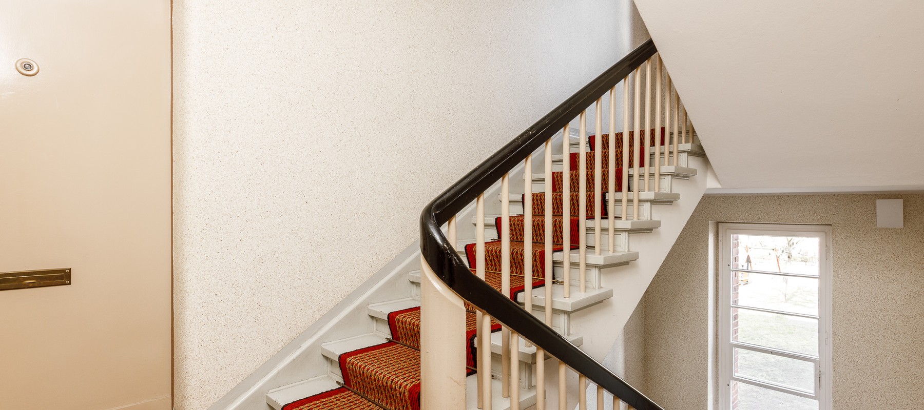 Well-maintained staircase with sisal carpet Well-maintained staircase with sisal carpet