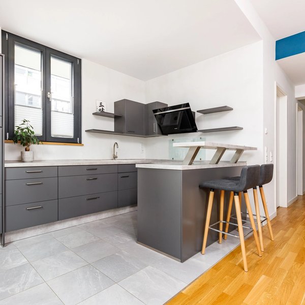 Open kitchen cooking island bar stools tiled floor