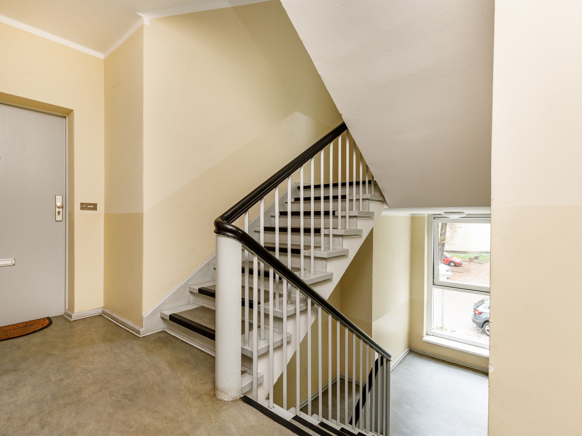 Well-maintained stairwell with linoleum flooring 