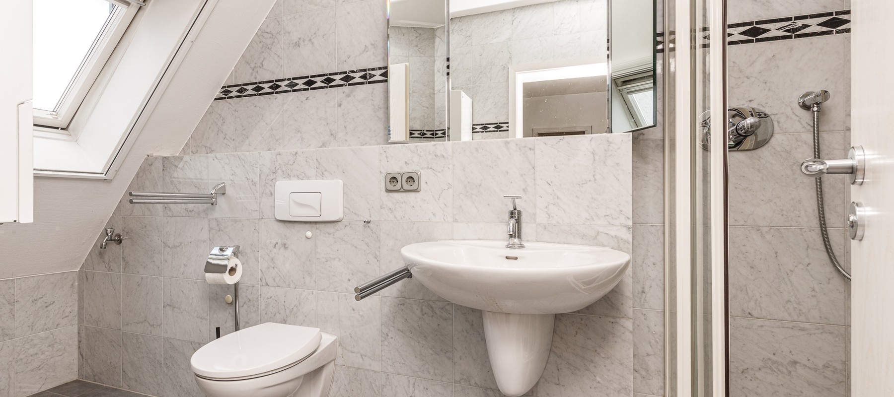 Daylit shower bathroom with wall-mounted WC Daylit shower bathroom with wall-mounted WC