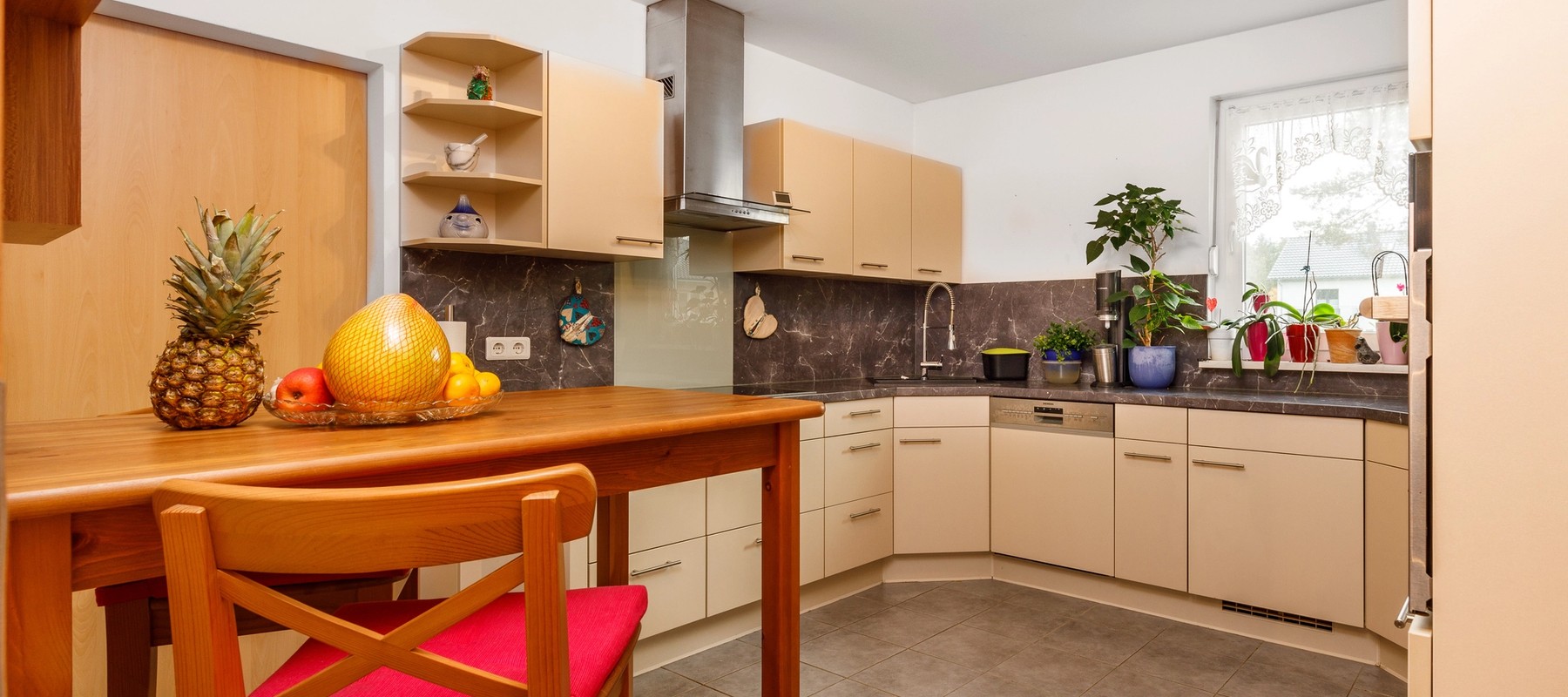 Küchenbereich mit moderner Einbauküche und Hauswirtschaftsraum Küchenbereich mit moderner Einbauküche und Hauswirtschaftsraum