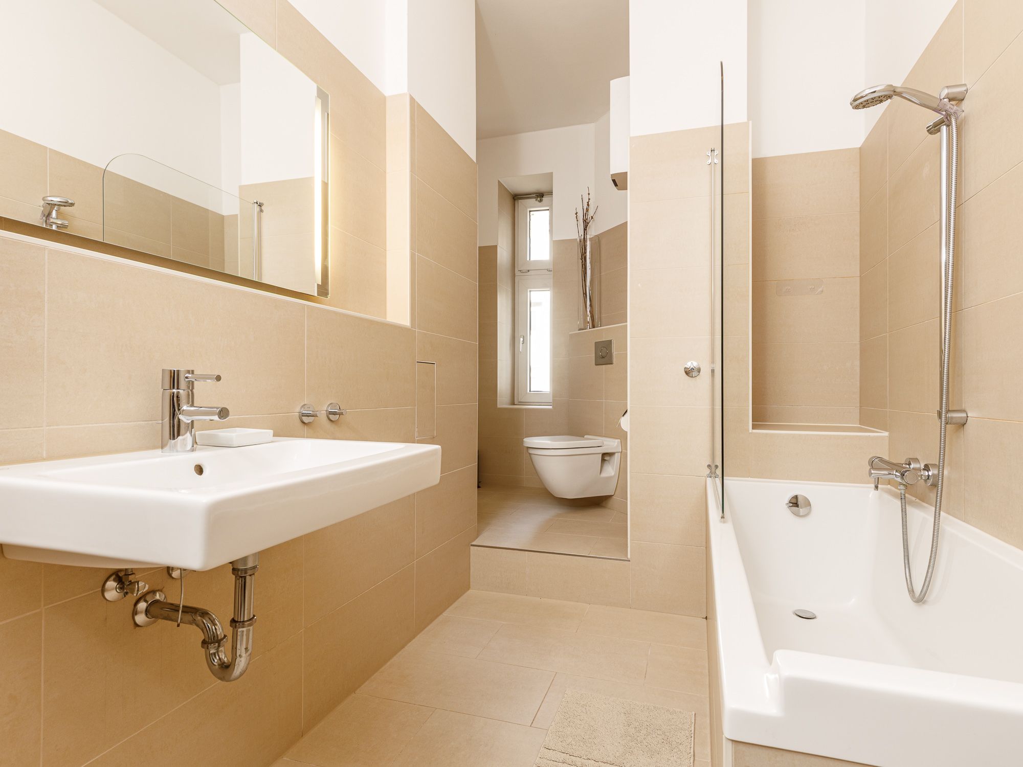 Modern, daylit bathroom with bathtub and shower 