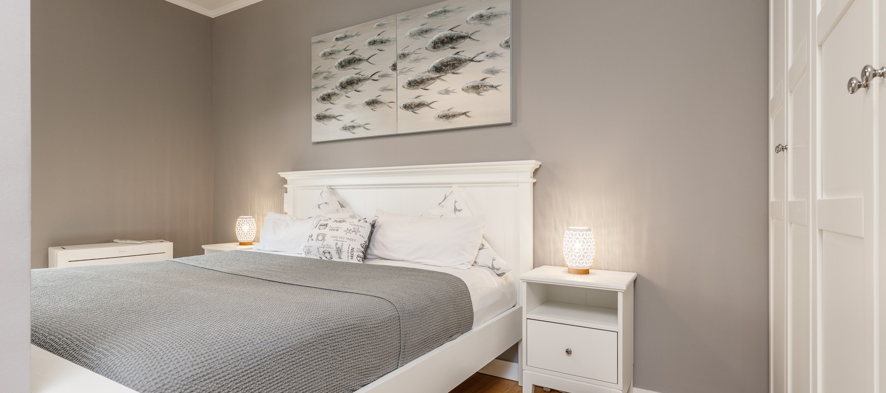 Sleeping area with bed and wardrobe Sleeping area with bed and wardrobe