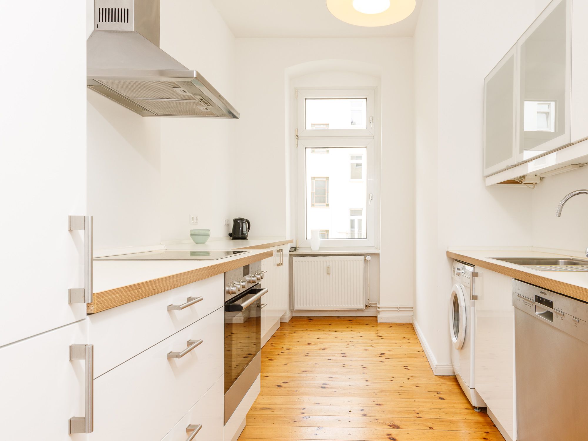 Separate kitchen area with appliances 
