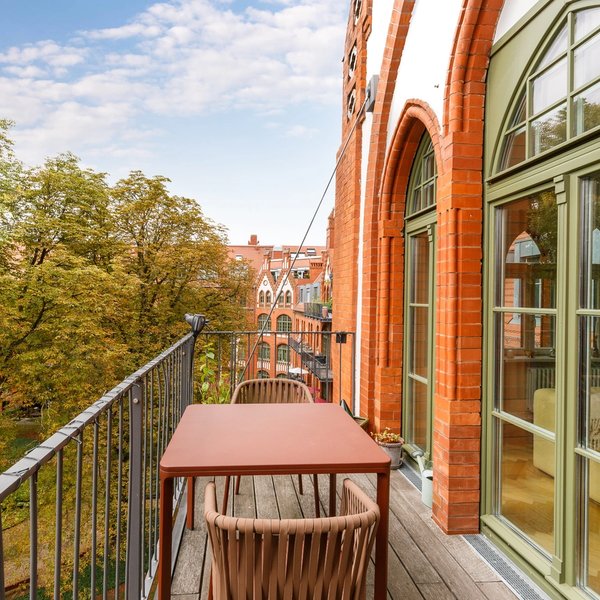 balcony green views brick architecture