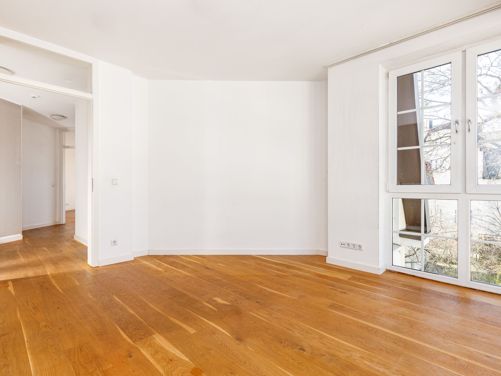 Open dining and living area with parquet floor