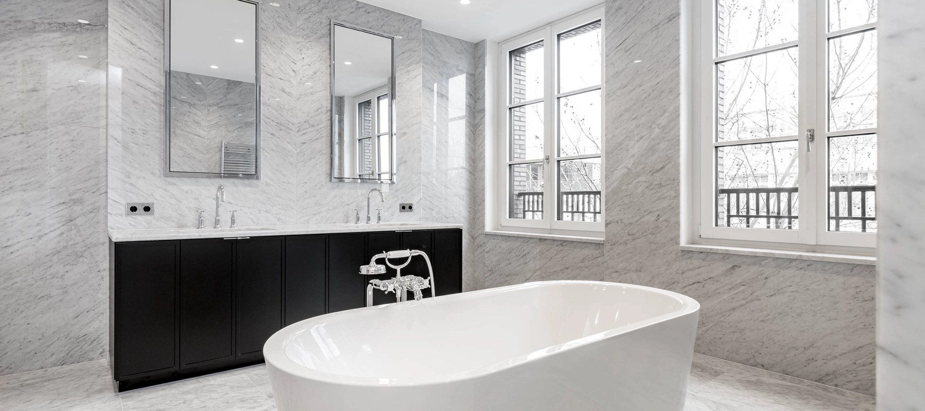 Luxurious bathroom with freestanding bathtub and marble tiles Luxurious bathroom with freestanding bathtub and marble tiles