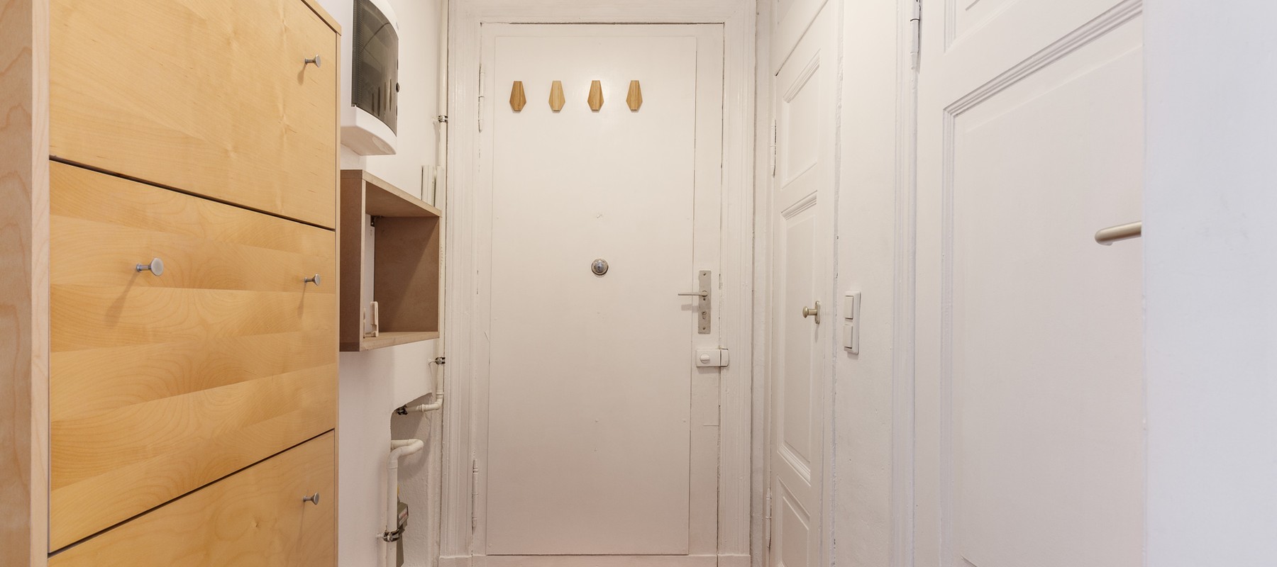 Hallway area with built-in closet and coat rack Hallway area with built-in closet and coat rack