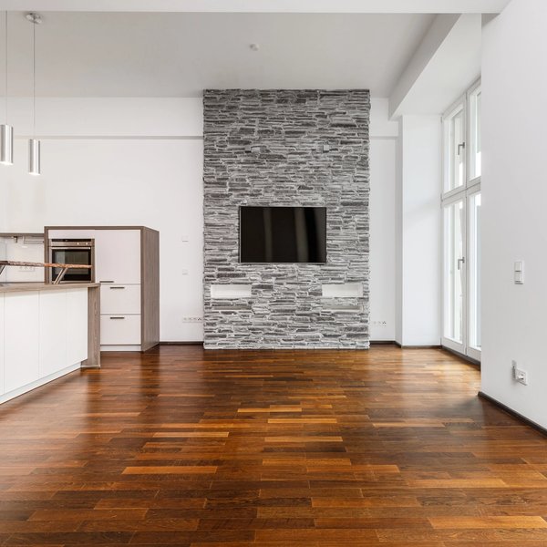 living area open-plan kitchen stone wall television