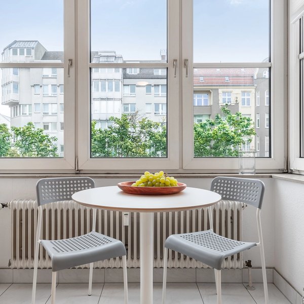 Dining area table chairs window radiator