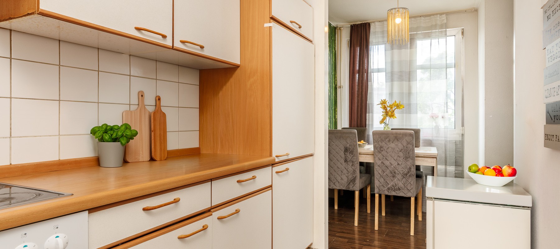 Partially-open kitchen area with appliances Partially-open kitchen area with appliances
