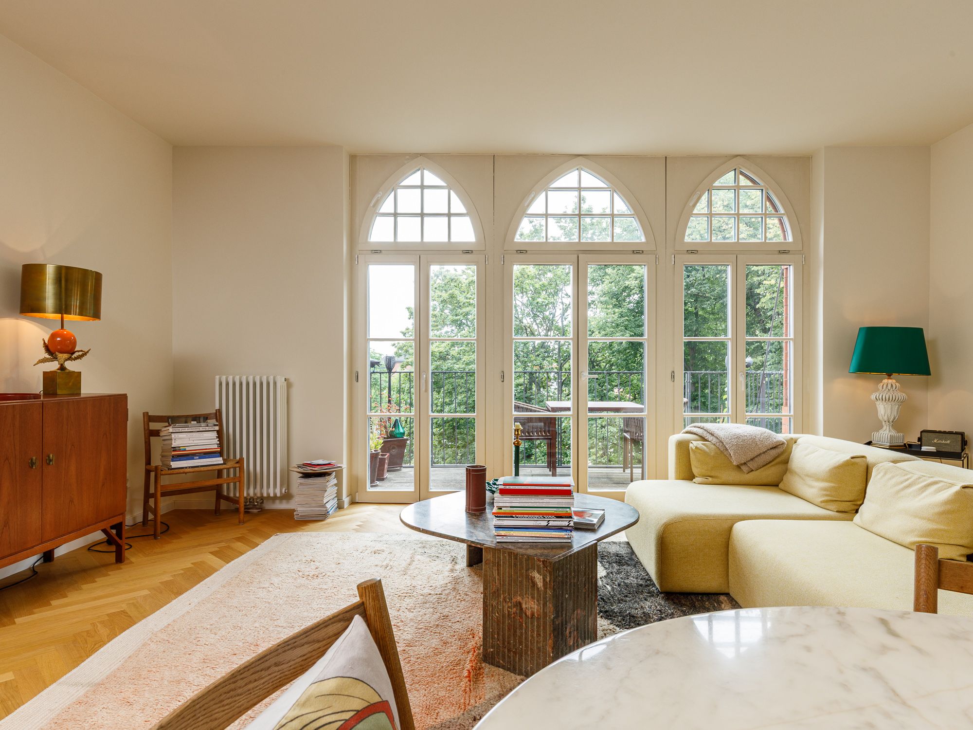 Living area with large window sections and balcony 