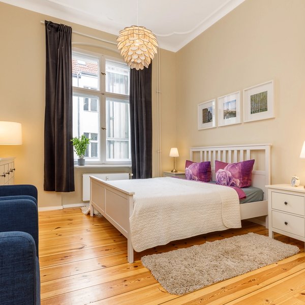 Schlafzimmer Doppelbett Nachttische Deckenleuchte Holzdielen