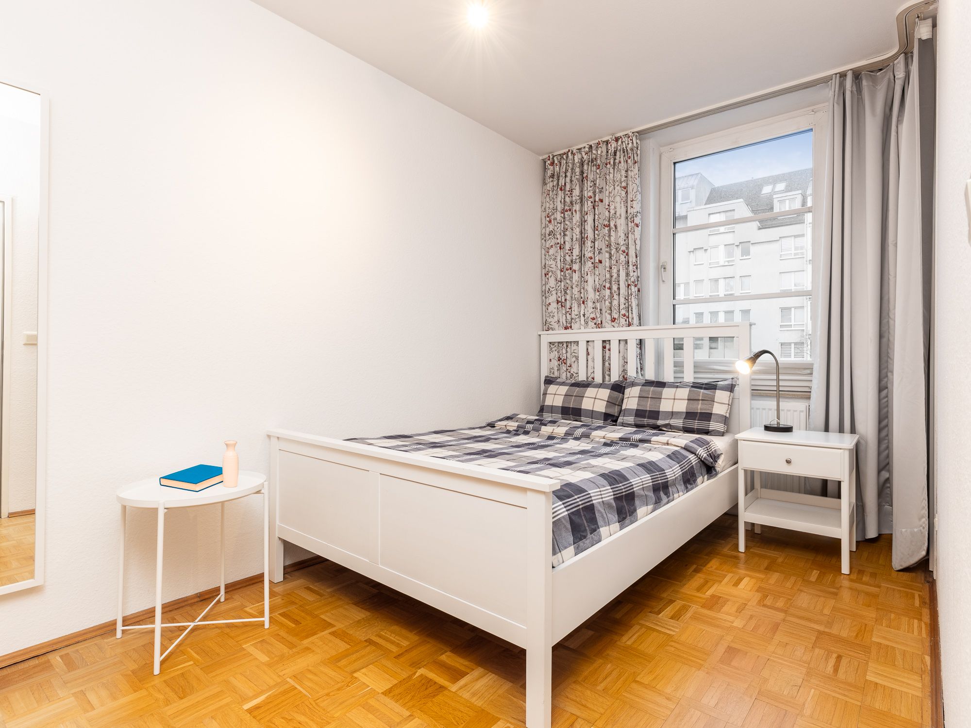 Charming bedroom with parquet flooring 
