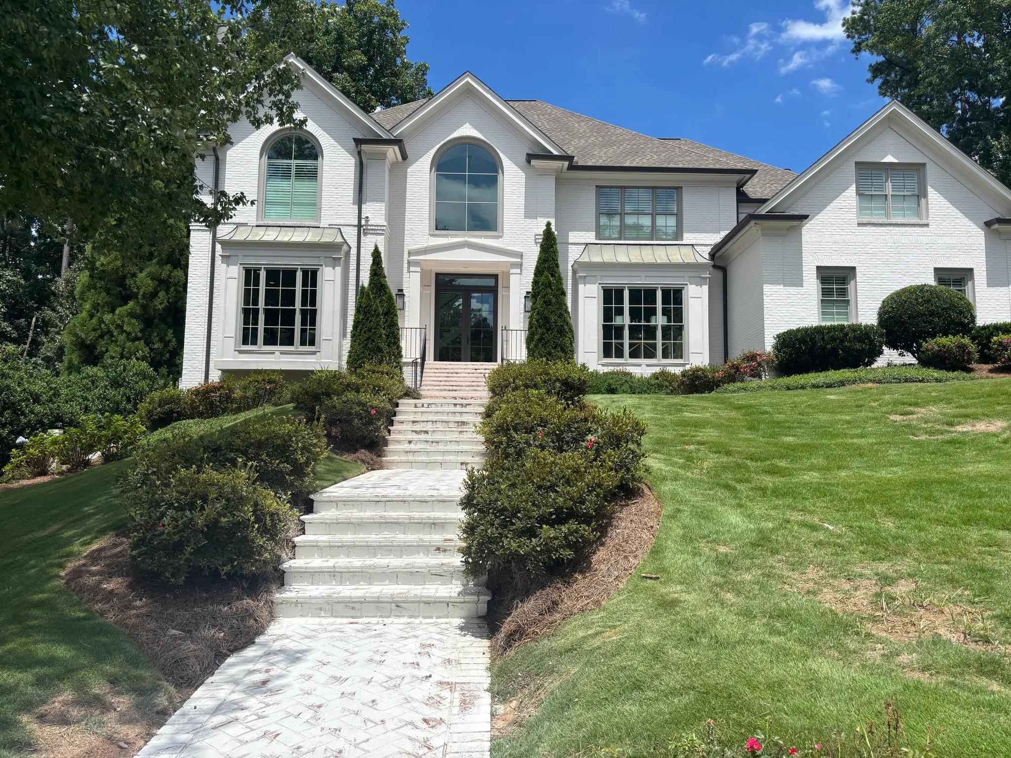 White painted brick home in Brookhaven by OVO Painting