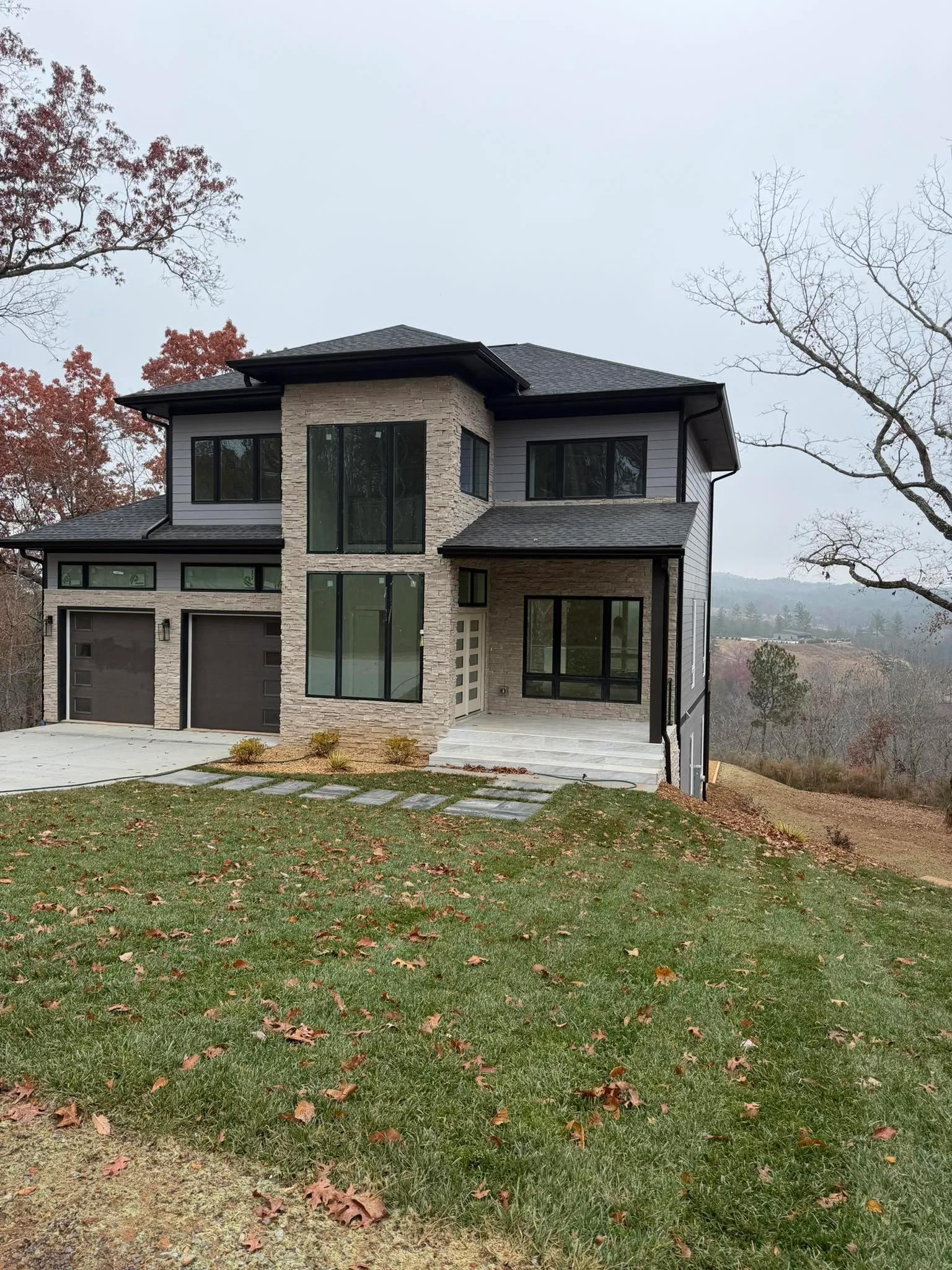 Grey siding with black gutters in Decatur by OVO Painting