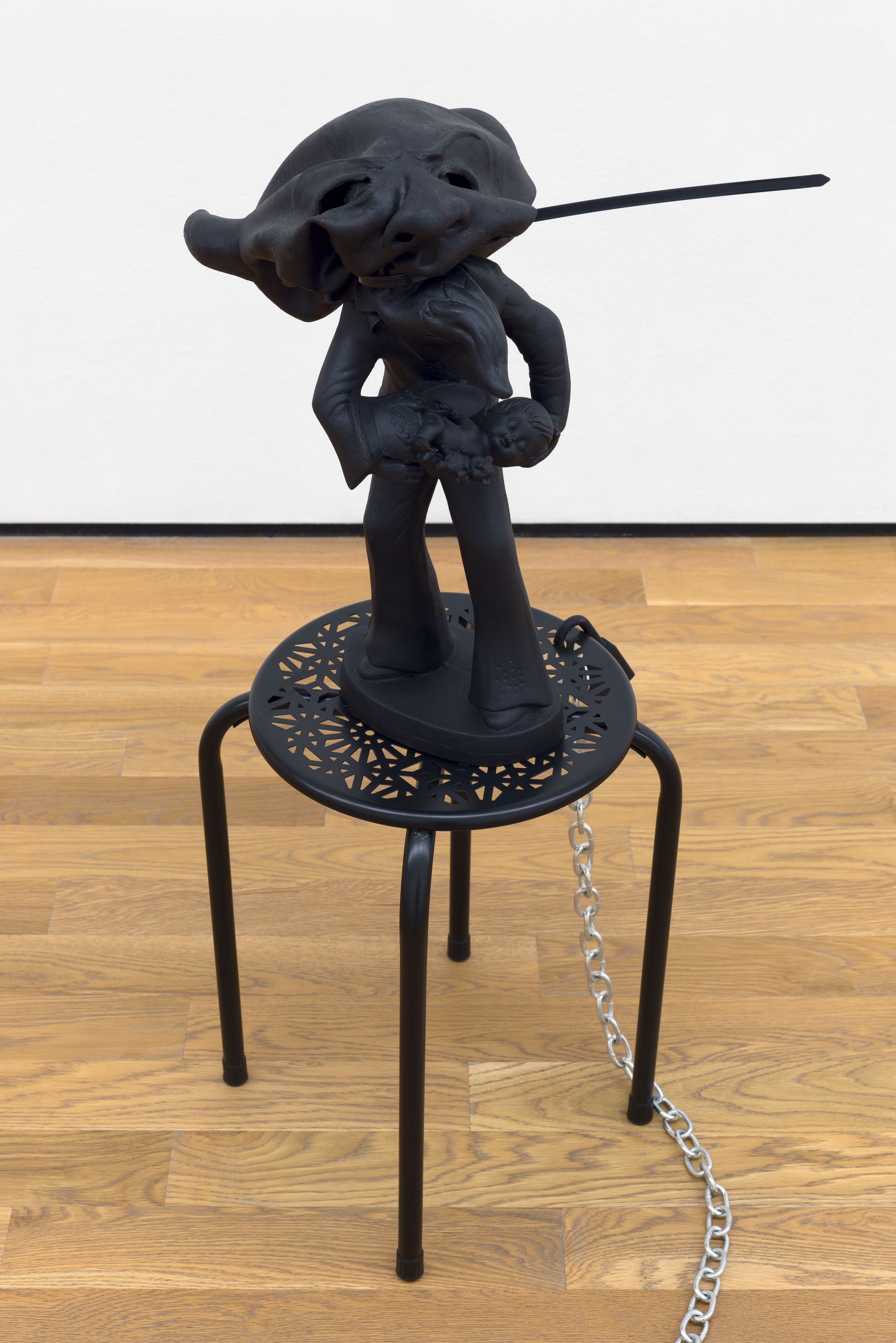 Brian Kokoska, Lonesome Cowboy (Dead Elvis), 2016, ceramic, rubber mask, acrylic, plastic, metal table, lock, double bit axe, cable tie, dimensions variable