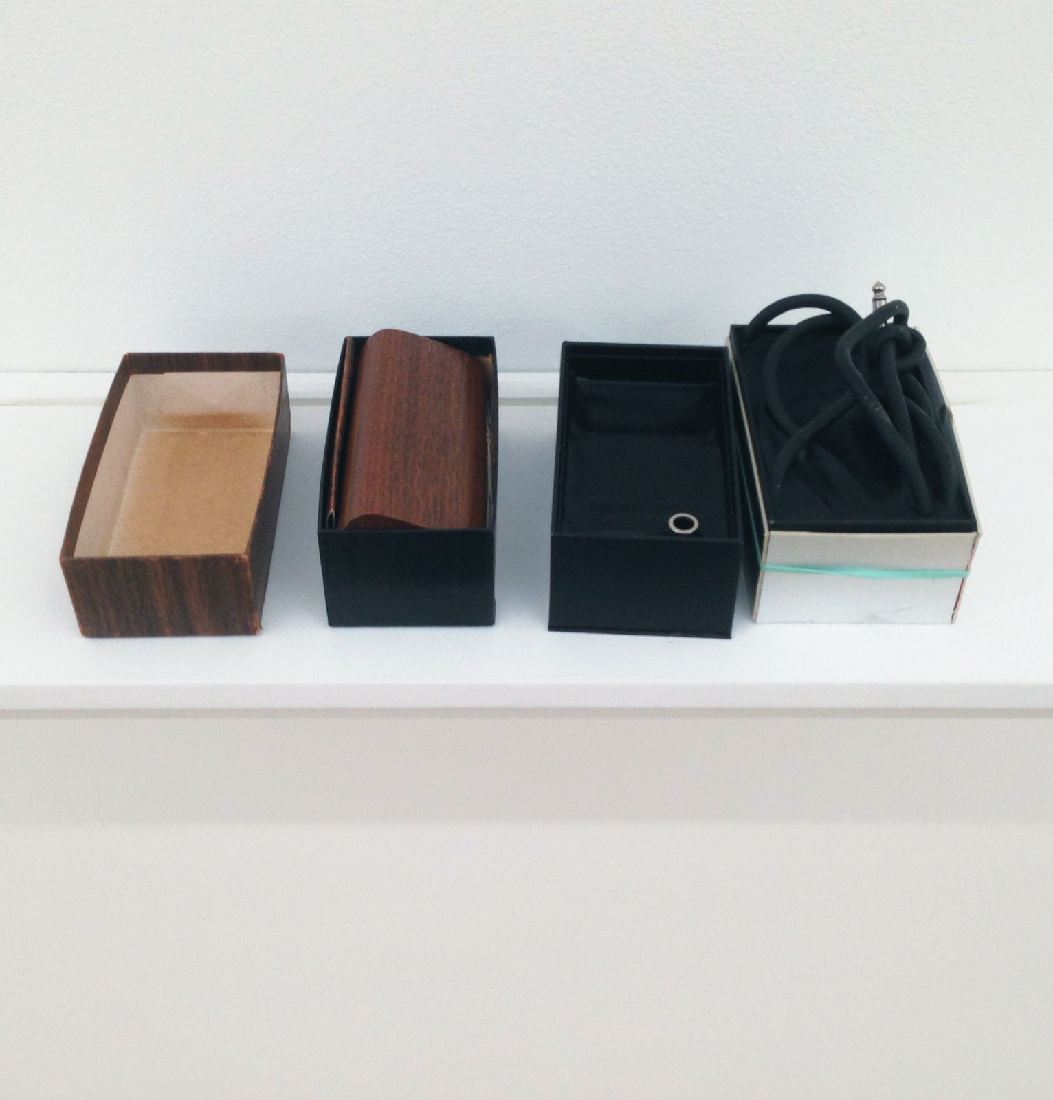 Bradley Kronz, UNTITLED, 2013, paper, boxes, disc cleaner, instrument cable, wax, 3 × 16 × 5 in.