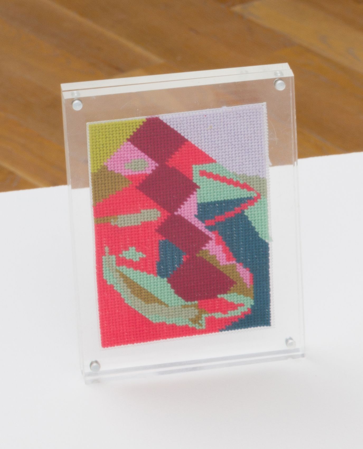 Steve Reinke, Untitled (needlepoint), 2021, floss on plastic backing, 5 1/2 x 3 5/8 in.