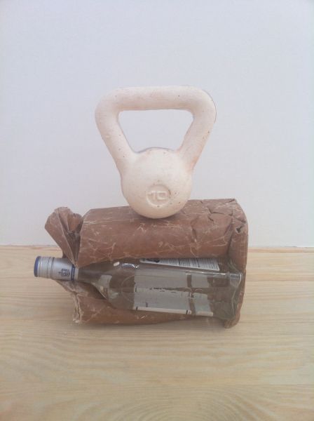 Cassie Raihl, HEAVY SIPS, 2013, tequila bottle, brown paper bag, wax, plaster, 15 × 12 × 4 in.