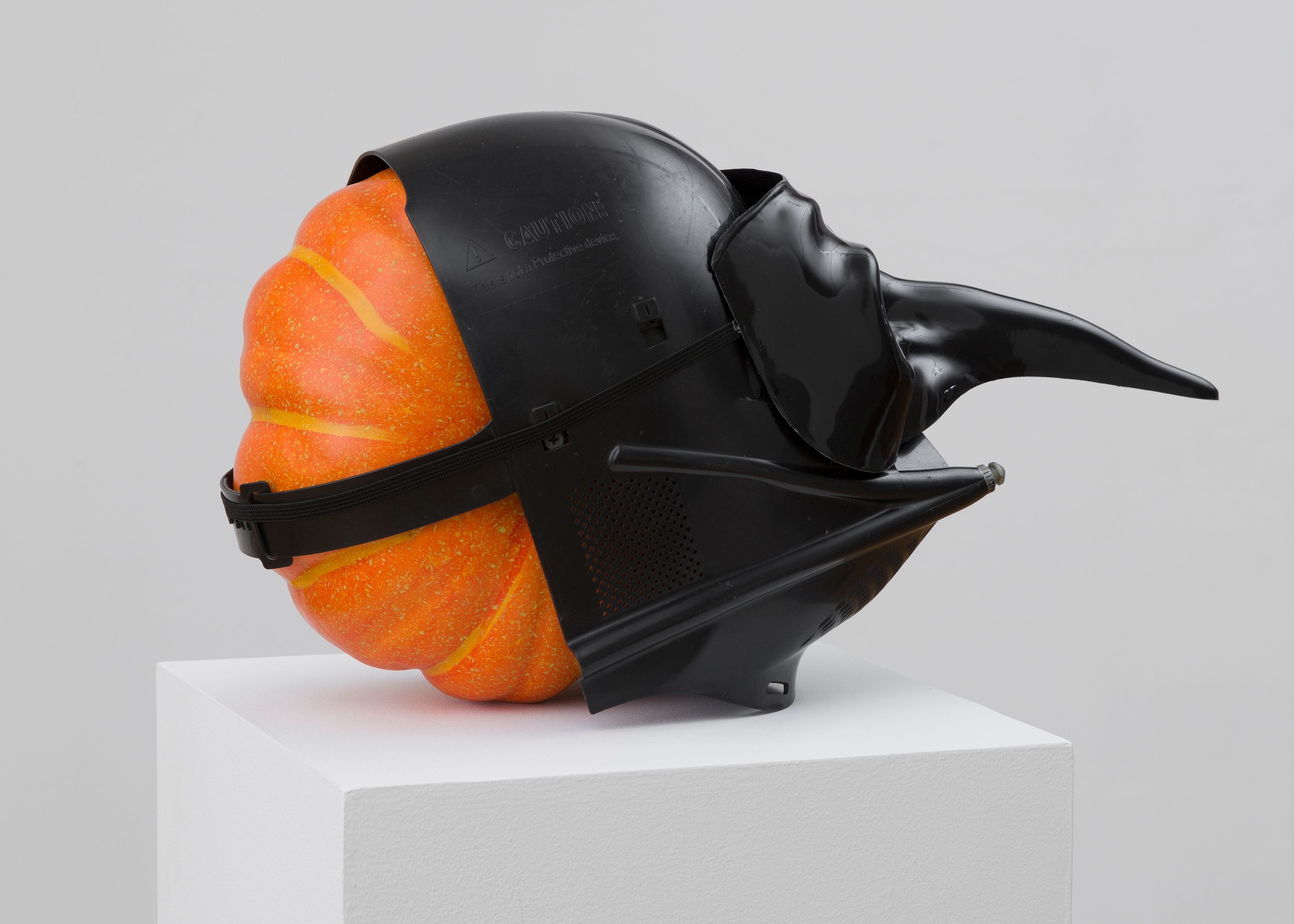 Danny McDonald Pumpkin in a Mask in a Mask, 2017, detail of foam, pumpkin, plastic masks, pedestal, 19 x 8 x 10 in. (48.3 x 20.3 x 25.4 cm), pedestal dimensions: 12 x 12 x 41 in. (30.5 x 30.5 x 104.1 cm) 
