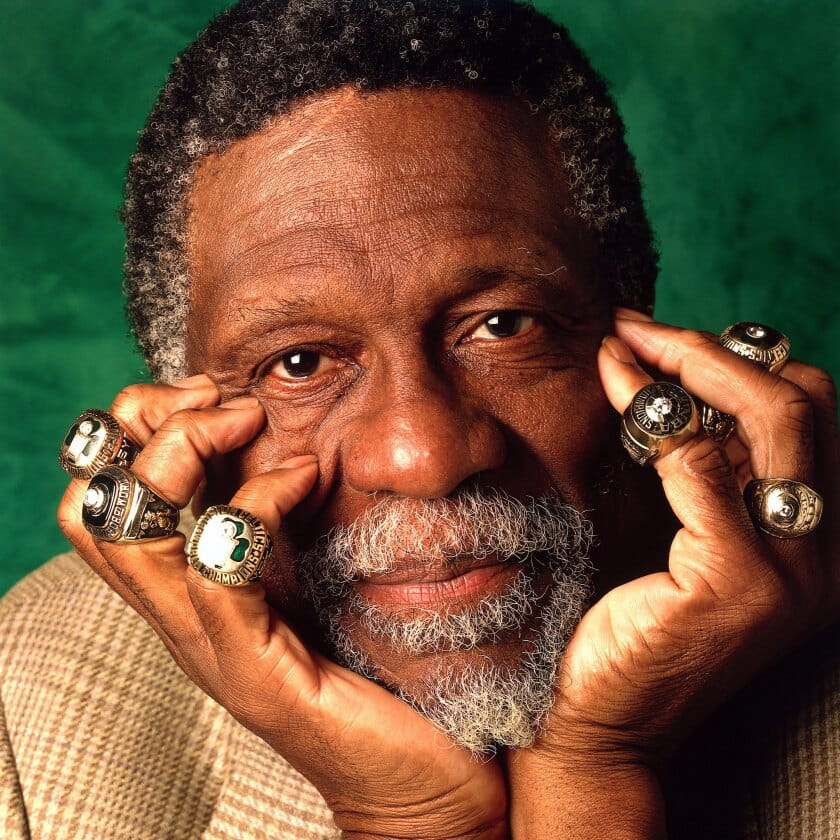 Bill Russell holds his face, his fingers adorned with NBA Championship rings.