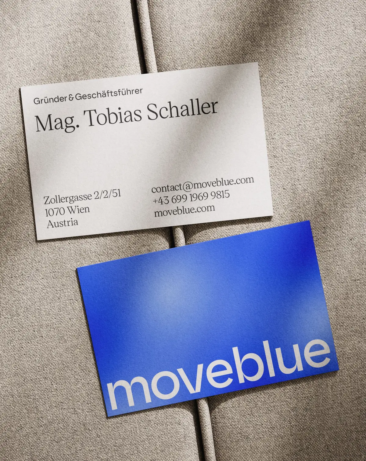 Business card with name tag on fabric surface