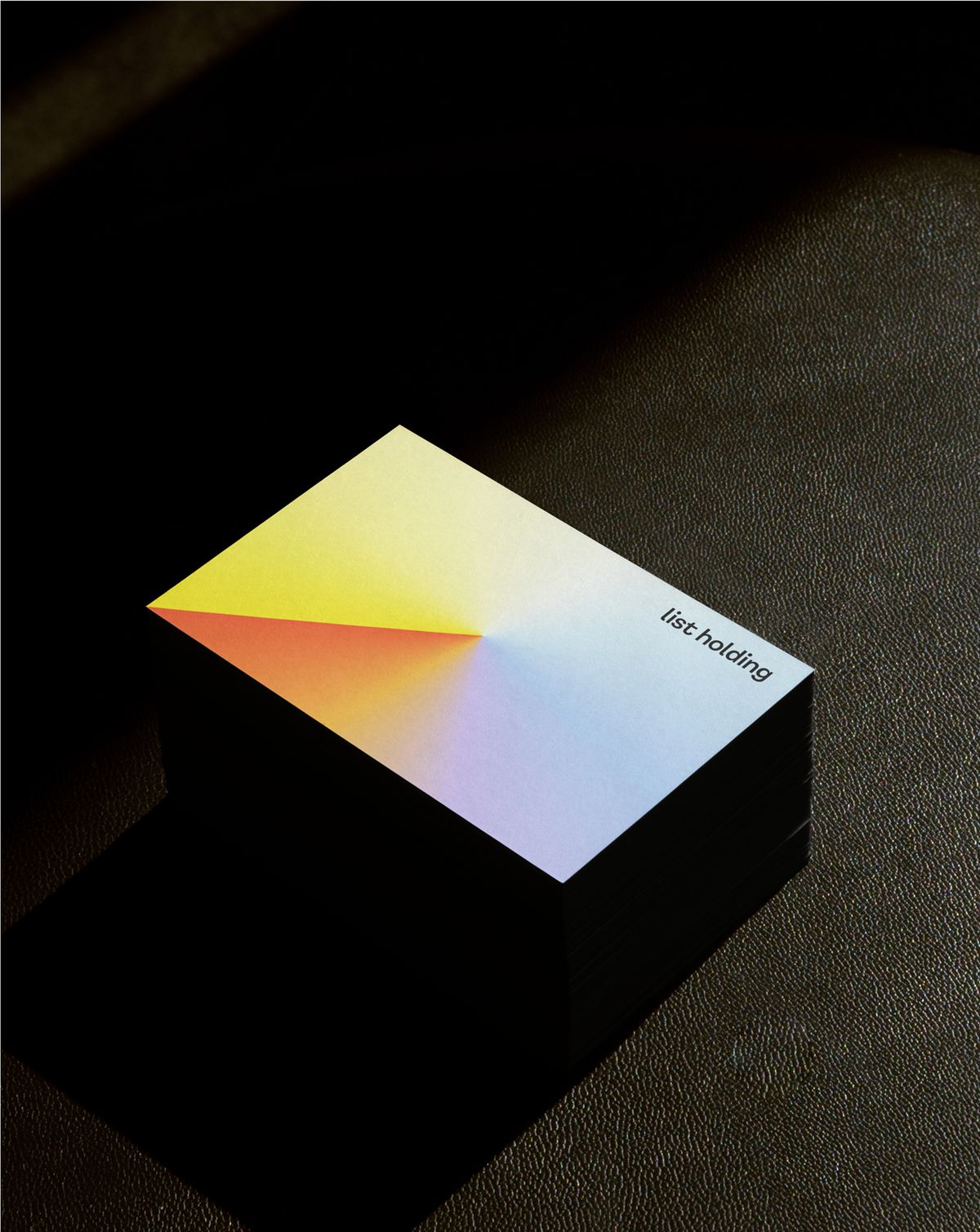 Visitenkarten mit Regenbogenverlauf und Logo auf schwarzem Hintergrund
