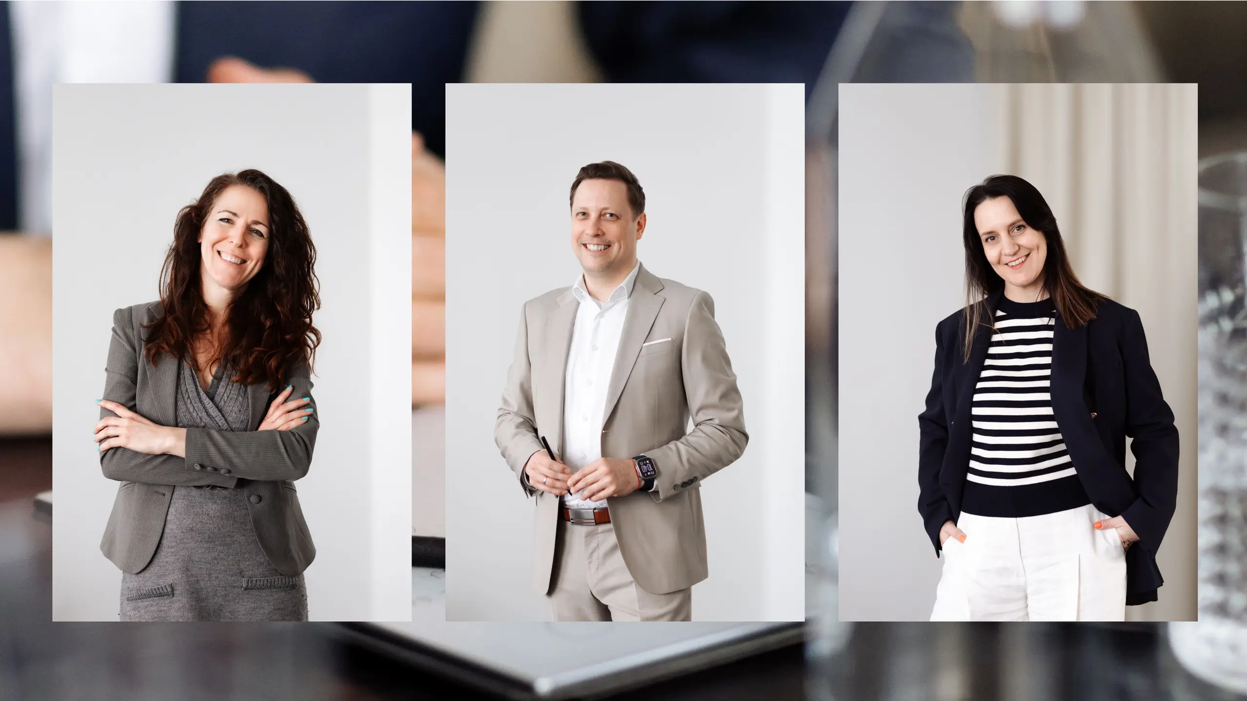 Three people smiling in a modern work environment