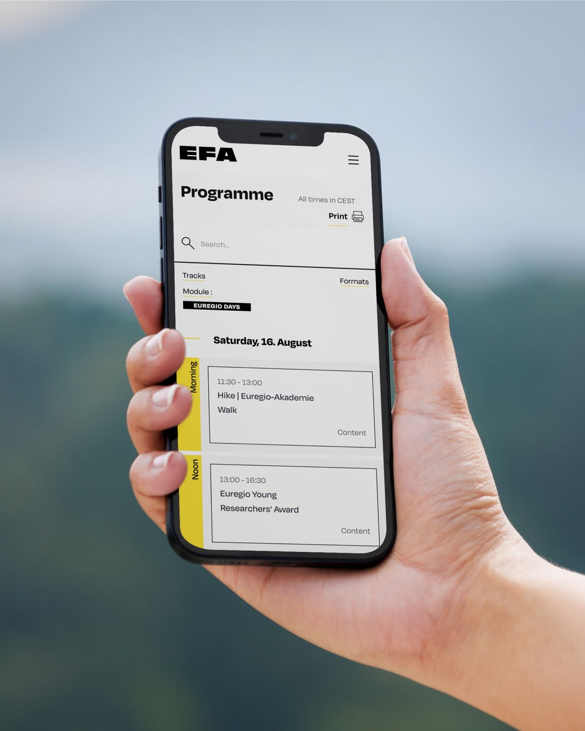 Smartphone mit Alpbach-Zeitplan in der Hand gehalten