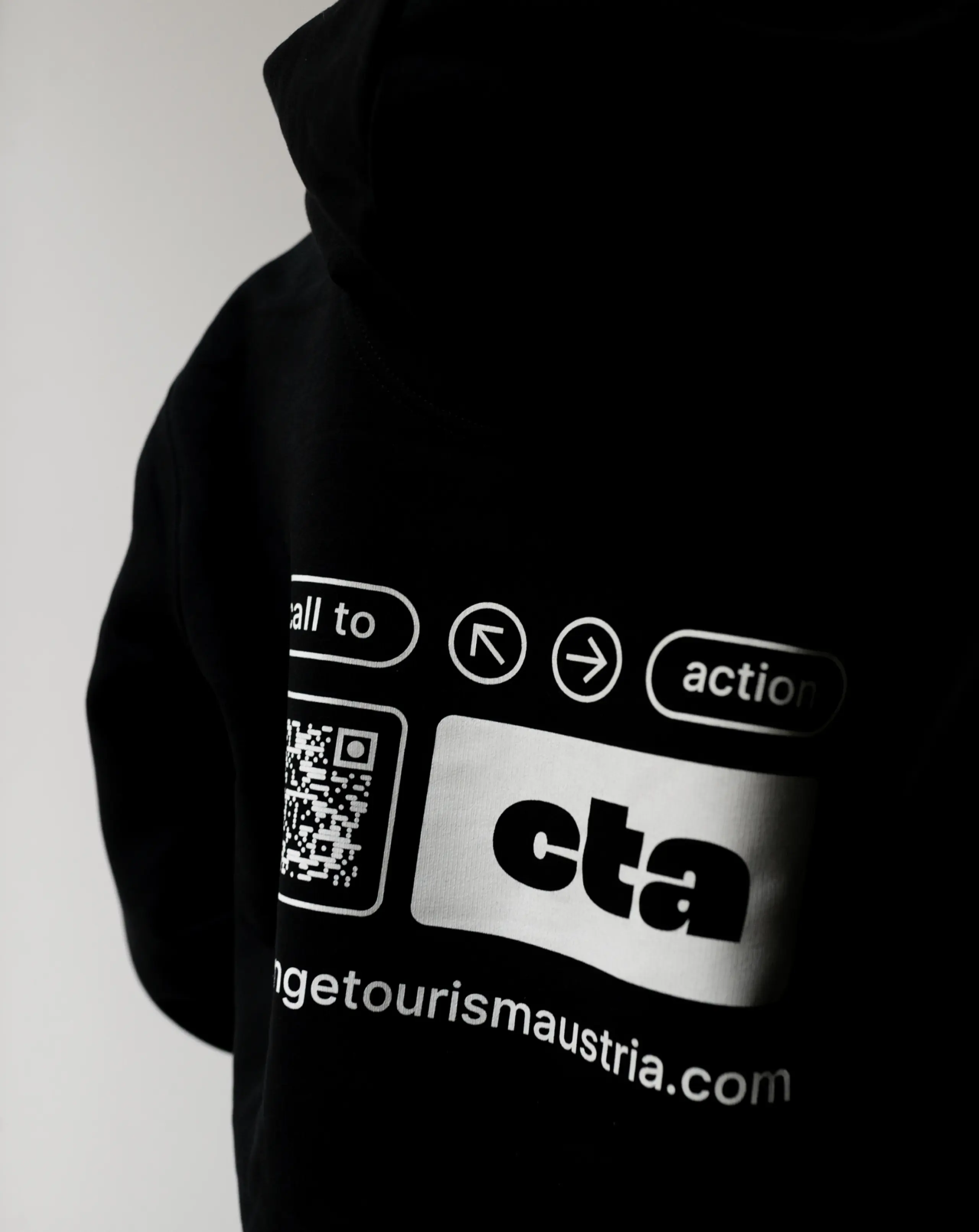 Merch pullover shows CTA logo and QR code to the website