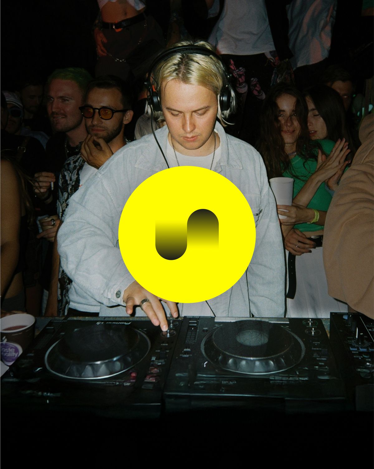 DJ mit Publikum, gelbes Seeqnc-Logo im Vordergrund