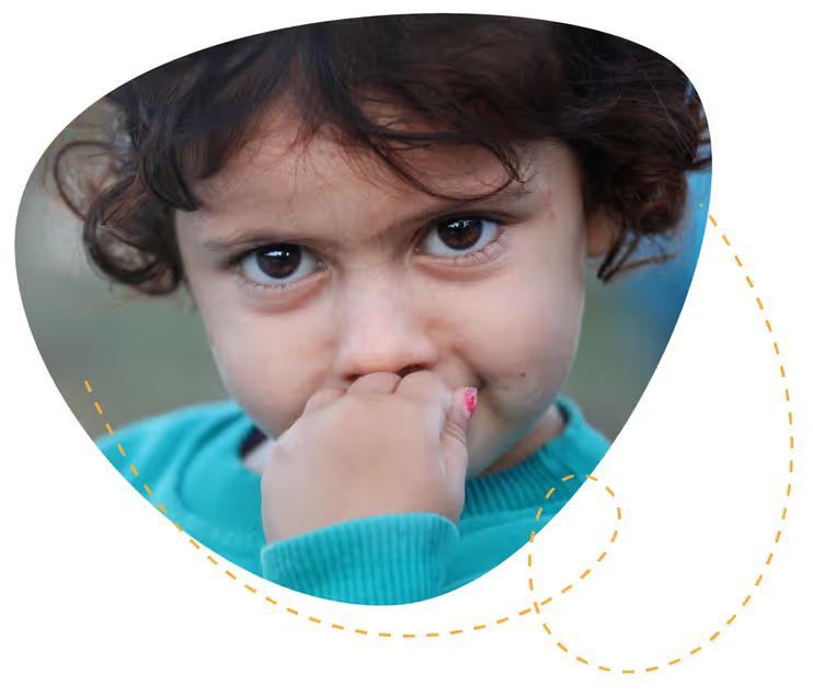 Young child with a hand over their mouth