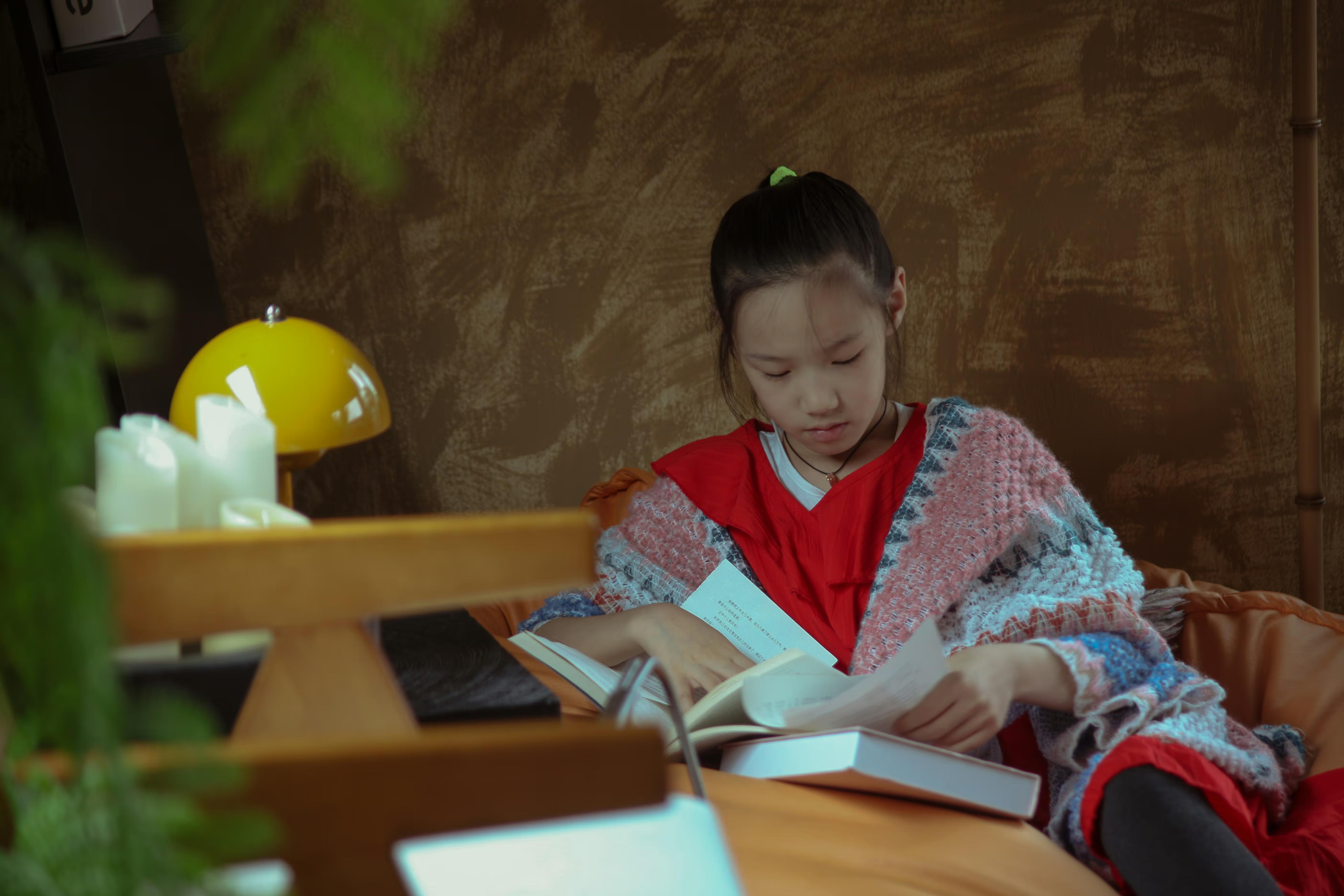 Girl reading a book at a desk