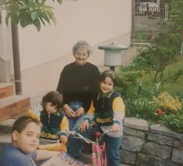 Tajna Vran as a child, with family in a garden