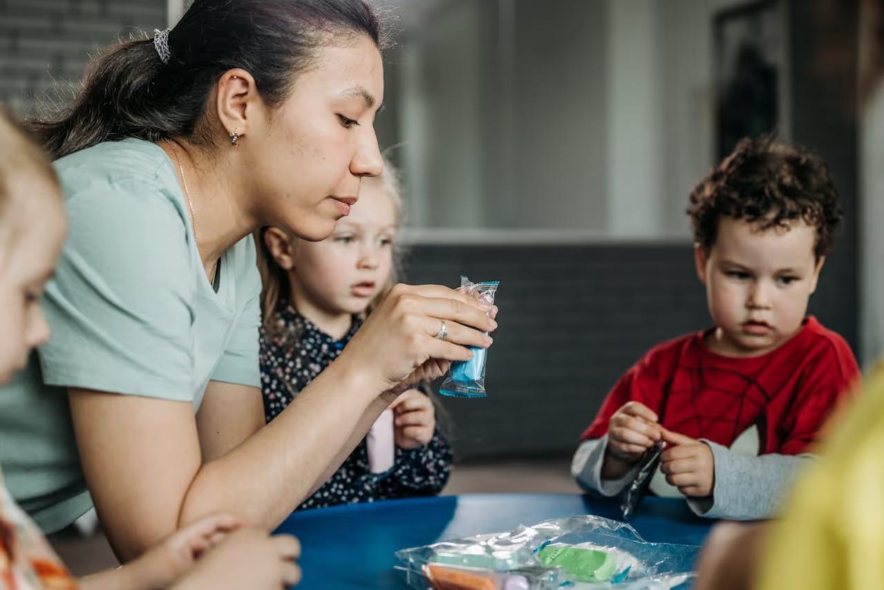 Educator helping young children with a hands-on activity