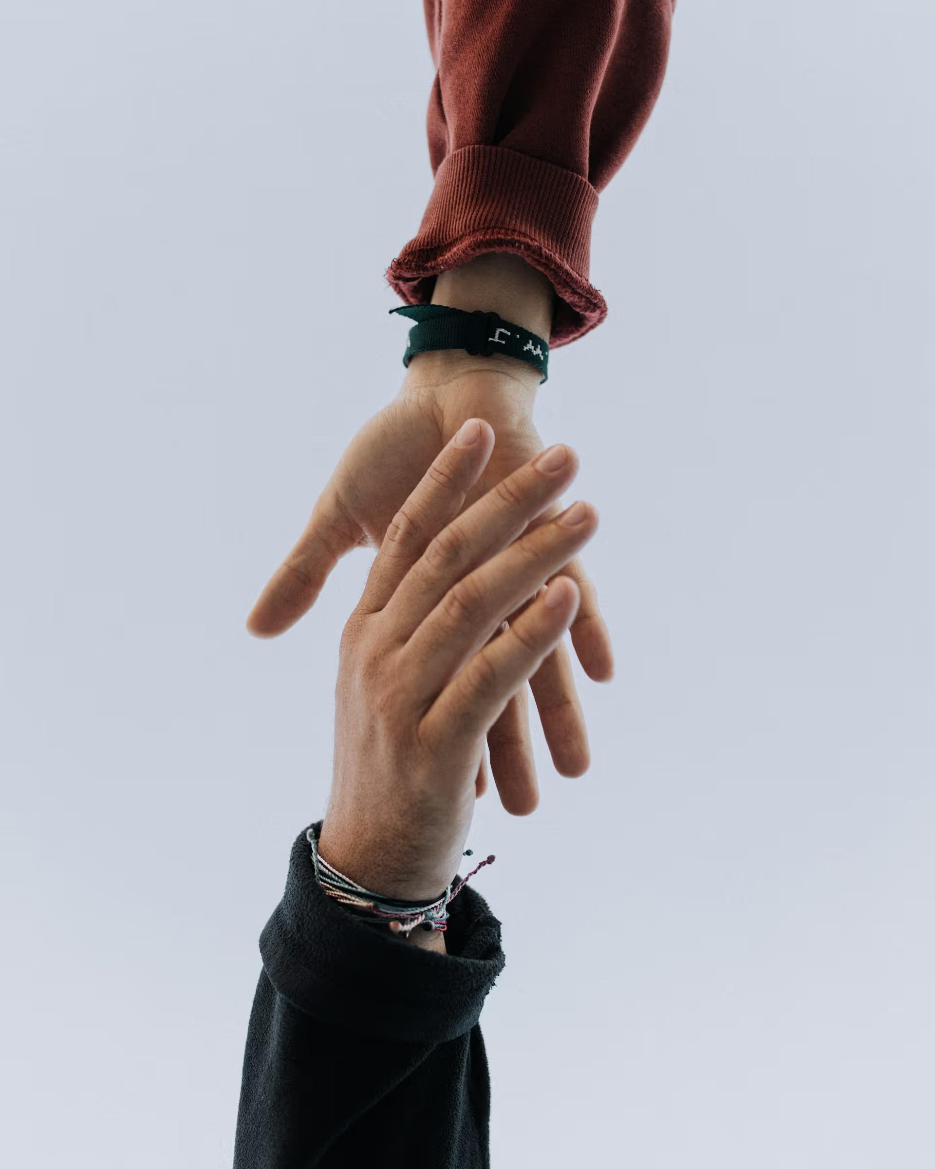 Two hands reaching towards each other