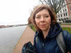 Woman standing beside a canal