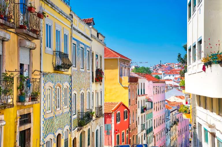 Colourful tiled houses on a steep street in Alfama, Lisbon