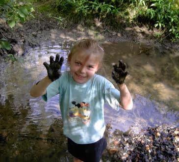 Veronika Kanova as a child, playing in a stream