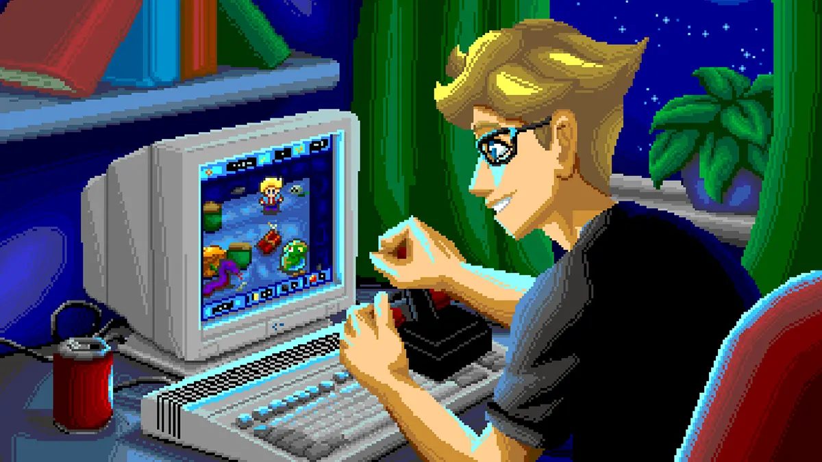 Un giocatore utilizza un computer Amiga per giocare a Kaboomania in una scena dal sapore retro